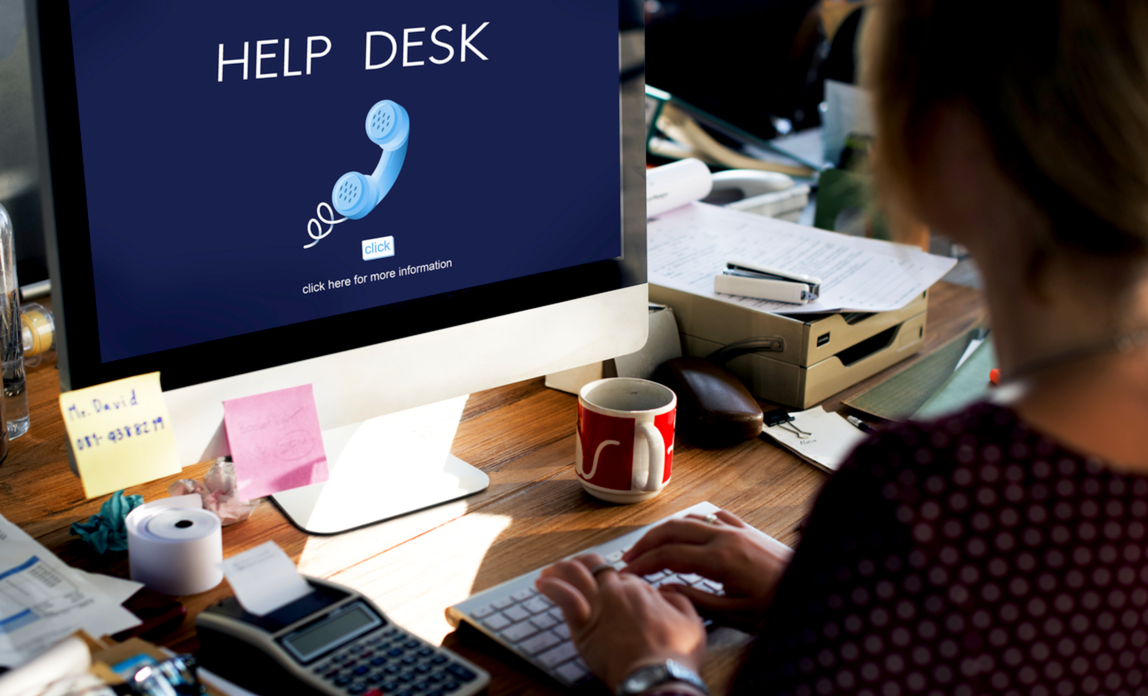 Employee managing IT support requests at her busy desk