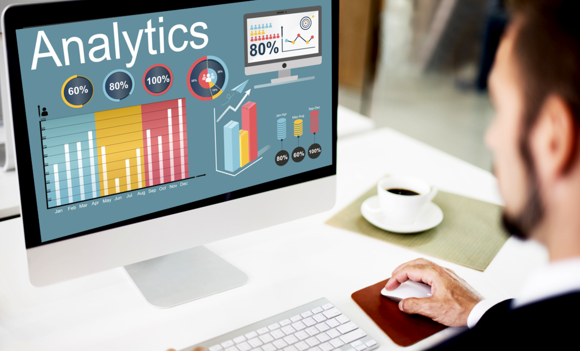 Man looking at web analytics on monitor - Monitoring your web traffic