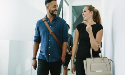 Two colleagues leaving work at the end of a four-day working week