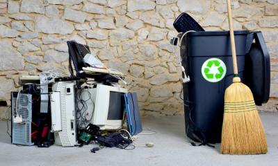 IT equipment placed next to a recycling bin