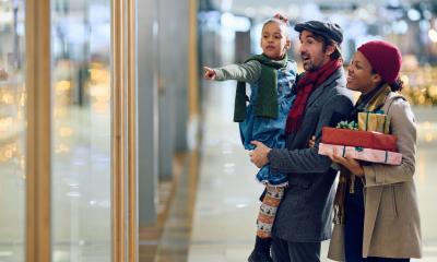 A mixed-race family are window shopping for Christmas gifts