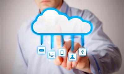 A man interacts with a cloud symbol representing various cloud services
