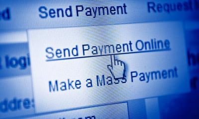 Choosing accounting software Online accounting software being used an a computer to send a payment