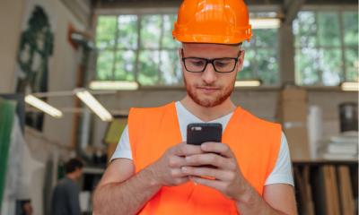 Builder using a finance app while during his working day