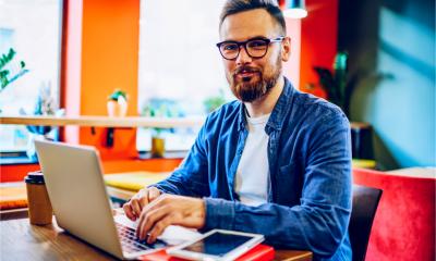 An attractive young man works on his laptop
