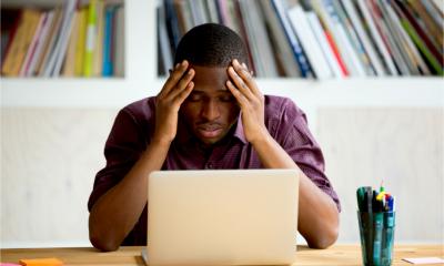A businessman looks upset and frustrated after finding out his firm has been targeted by fraudsters.