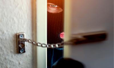 A masked burglar breaks into a house
