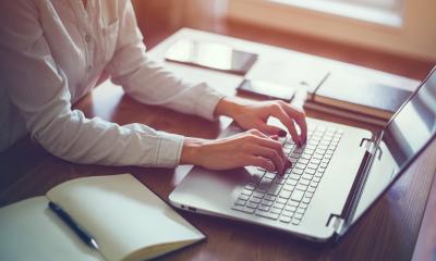 Dealing with staff with different IT abilities - checklist Close up of female office working typing on a laptop