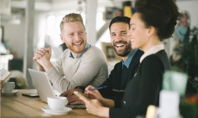Employees gathered at the table discussing a project