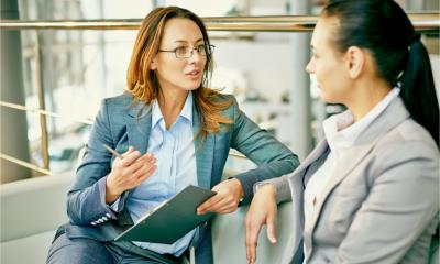A female manager talks to an employee about her financial wellbeing