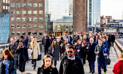Commuters walking across London bridge