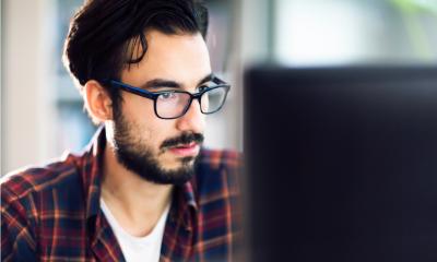 Man with glasses and red flannel shirt looks to find financial business support