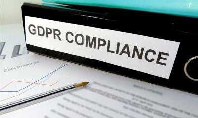 GDPR - your data protection responsibilities Black lever arch file with label GDPR compliance resting on some paperwork