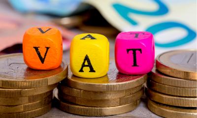 VAT letter cubes on coins concept VAT letter cubes on coins concept