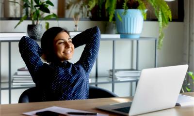 A relieved woman smiles as she submits her self assessment tax return