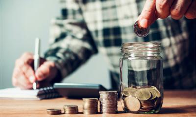 A male employee counts up how much he has saved while working from home