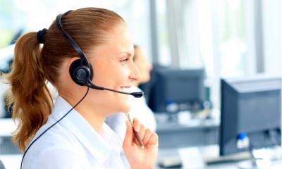A woman offers remote technical support over the phone
