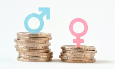 Male and female symbols on piles of coins Male and female symbols on piles of coins