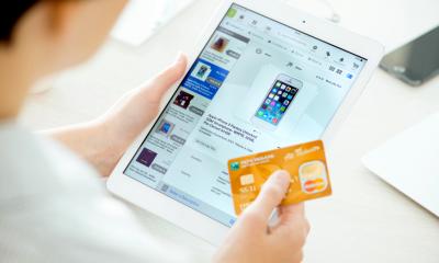 Person using card to make payment for online shopping