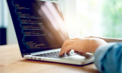 Close up of a woman's hands coding html and programming on a laptop. Web development web. Developer.