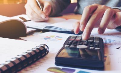 Businessman performing payroll calculations
