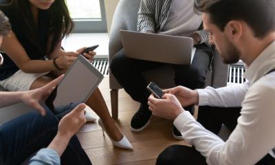 A sales team use their mobile devices to update their sales record using Microsoft Dynamics 365