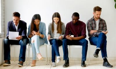 Multi-ethnic millennial people holding phones and resumes preparing for job interview
