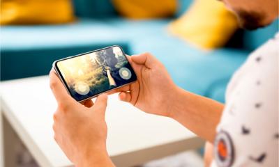 A man plays a game on his smartphone device
