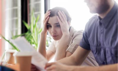 Businesswoman looking at documents with worry