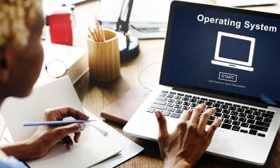 Woman using her laptop to download operating system software
