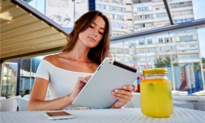 A young woman uses instant messaging on her mobile device to stay in touch with colleagues