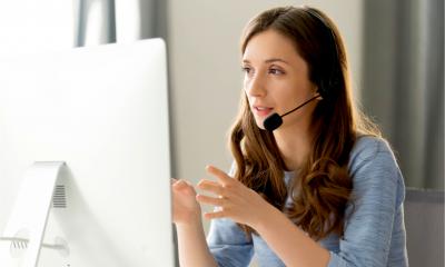 A woman has a serious conversation on the phone using a headset