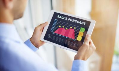 Aman updates his sales forecast on a tablet device