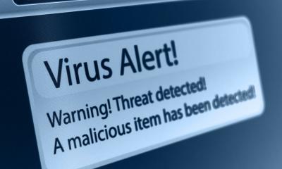 A virus warning appears on a computer screen