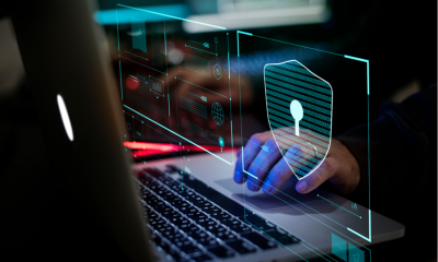 Hand typing on laptop with lock symbol