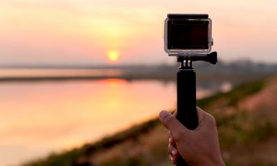 A man uses a handheld video camera