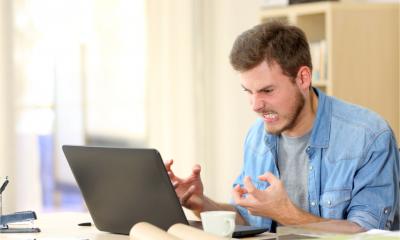 An entrepreneur is furious at his slow PC which keeps freezing - speed up your computer concept.