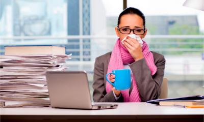 Young businesswoman sick in the office