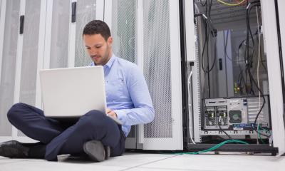 IT manger installs system upgrades in the server room