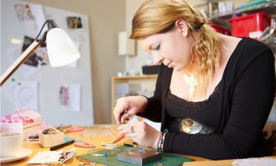 Woman creating her own products for sale as an additional source of income
