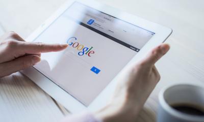 Someone is using a tablet to find information using a search engine