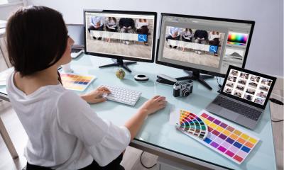 Women working on multiple screens in her home office