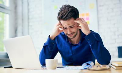 Man suffering from headache in the workplace