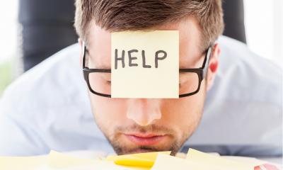 Stressed employee sitting at his desk